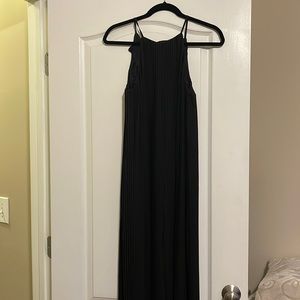 Pleated black jumpsuit with halter neckline